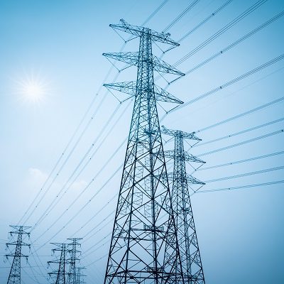 electricity transmission closeup pylon with a blue sky